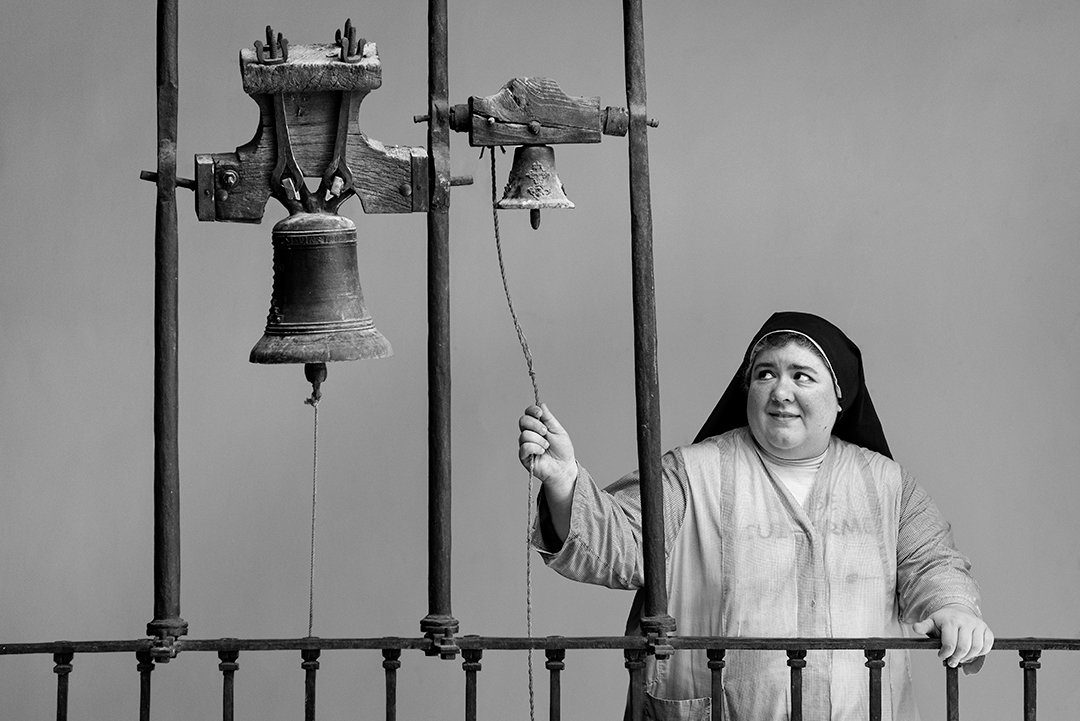 A nun pulling a bell rope.